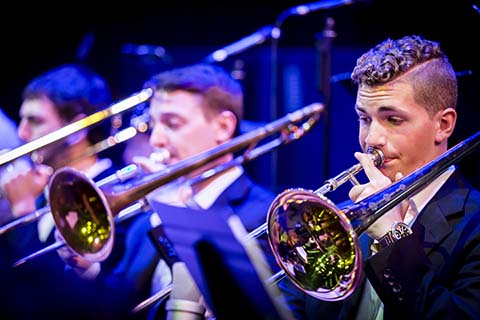 Trombone section of the Jazz band plays during a performance