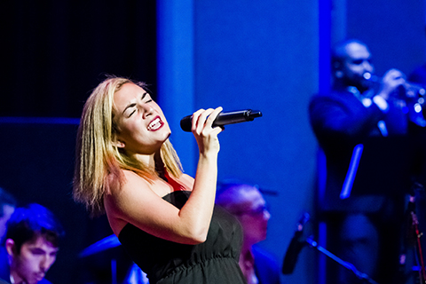 Woman vocalist takes the stage with the Jazz group